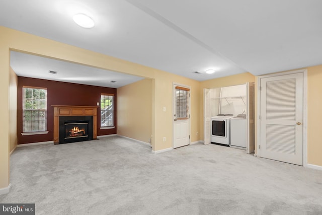 8078 Horseshoe Cottage Cir, Lorton, VA 22079 - kitchen with washing machine and dryer, carpet floors, and a fireplace with flush hearth