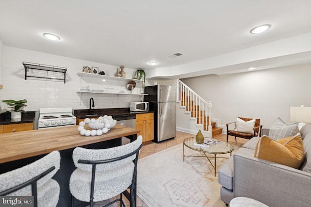 643 Keefer Pl NW, Washington, DC 20010 - living area featuring stairs, wet bar, light tile patterned flooring, and recessed lighting