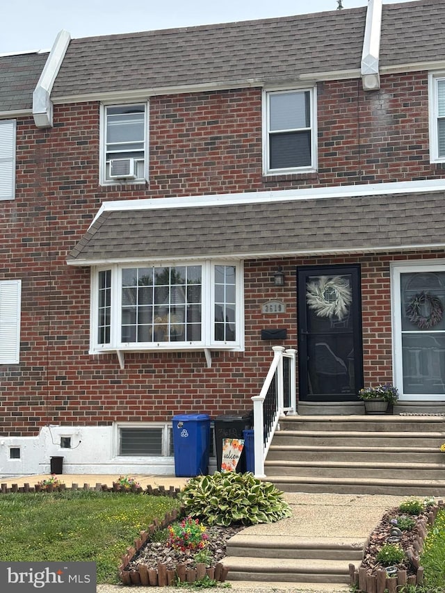 3619 Genesee Dr, Philadelphia, PA 19154 - doorway to property featuring brick siding, cooling unit, roof with shingles, and mansard roof