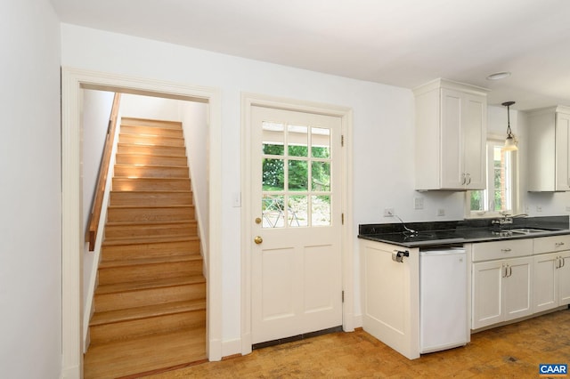 906 Old Farm Rd, Charlottesville, VA 22903 - kitchen with dark countertops, healthy amount of natural light, and white cabinetry