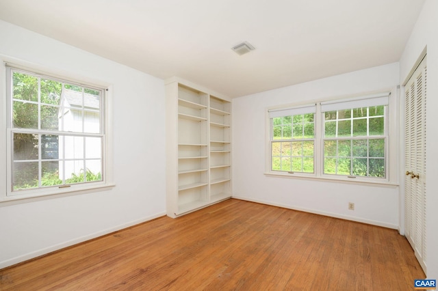 906 Old Farm Rd, Charlottesville, VA 22903 - unfurnished bedroom featuring light wood finished floors, multiple windows, and a closet