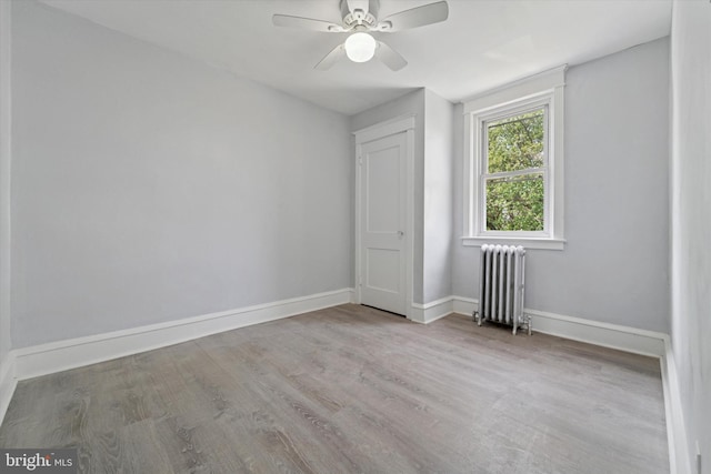 7139 Guilford Rd, Upper Darby, PA 19082 - spare room with radiator heating unit, wood finished floors, and a ceiling fan