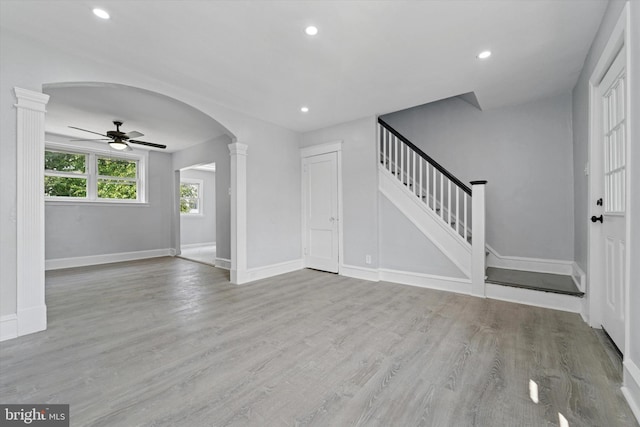 7139 Guilford Rd, Upper Darby, PA 19082 - unfurnished living room with arched walkways, a ceiling fan, recessed lighting, decorative columns, and wood finished floors