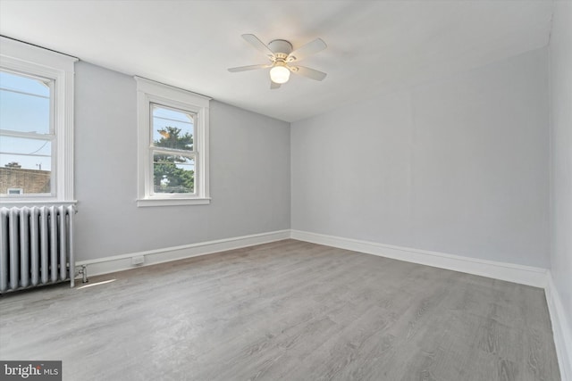 7139 Guilford Rd, Upper Darby, PA 19082 - spare room featuring radiator, a ceiling fan, and wood finished floors