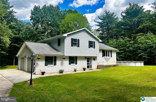 93 Sassafras, Lehighton, PA 18235 - tri-level home featuring concrete driveway, brick siding, a front lawn, a garage, and a shingled roof