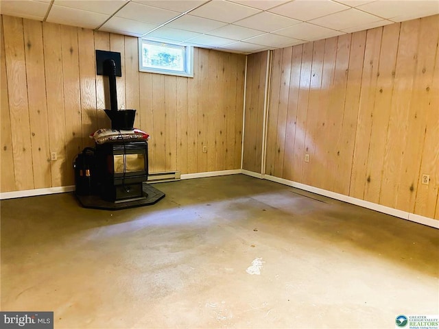 93 Sassafras, Lehighton, PA 18235 - below grade area with a wood stove, baseboard heating, wood walls, and a paneled ceiling