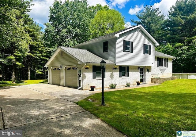 93 Sassafras, Lehighton, PA 18235 - tri-level home with an attached garage, brick siding, a front yard, driveway, and a shingled roof