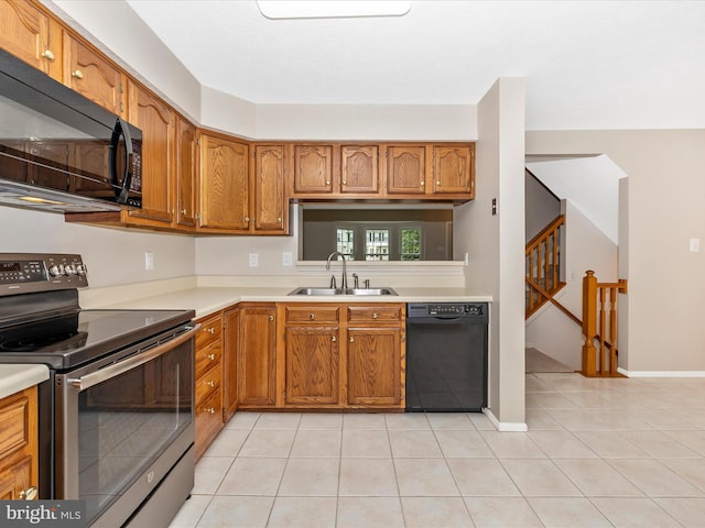 5220 Earles Ct, Frederick, MD 21703 - kitchen with black appliances, light countertops, brown cabinets, and light tile patterned flooring