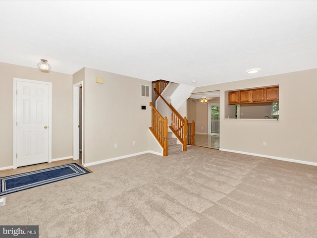 5220 Earles Ct, Frederick, MD 21703 - unfurnished living room with stairway, light carpet, and ceiling fan