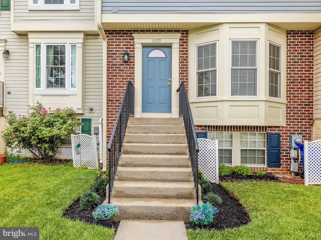 5220 Earles Ct, Frederick, MD 21703 - view of exterior entry with brick siding and a lawn
