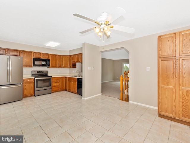5220 Earles Ct, Frederick, MD 21703 - kitchen with black appliances, light countertops, arched walkways, and light tile patterned floors