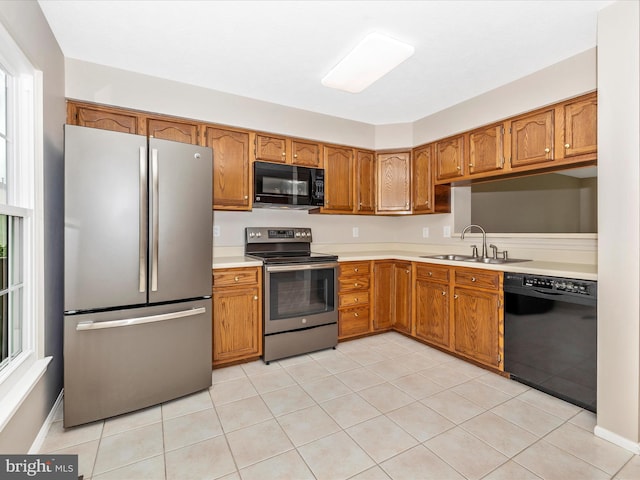 5220 Earles Ct, Frederick, MD 21703 - kitchen with black appliances, light countertops, brown cabinets, and light tile patterned flooring