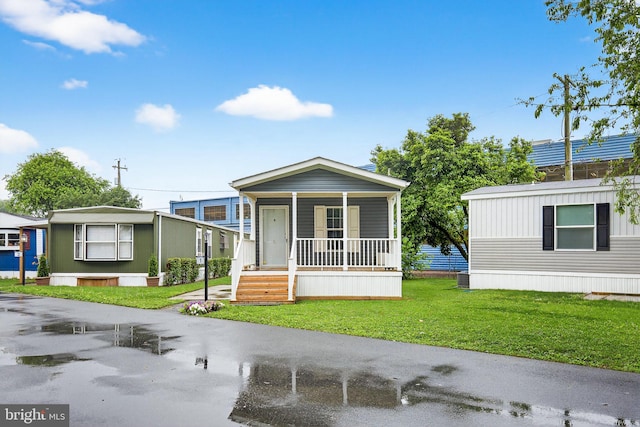 541 Furnace Hills Pike Unit 1, Lititz, PA 17543 - manufactured / mobile home featuring covered porch and a front yard