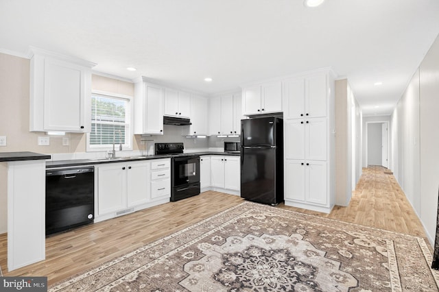 541 Furnace Hills Pike Unit 1, Lititz, PA 17543 - kitchen with black appliances, under cabinet range hood, light wood-type flooring, white cabinets, and recessed lighting