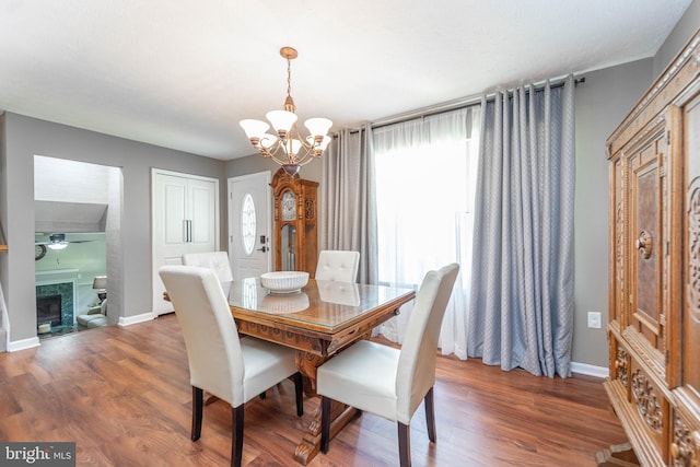 7781 Monaghan Rd, Glen Burnie, MD 21060 - dining space with a chandelier, wood finished floors, and a tile fireplace