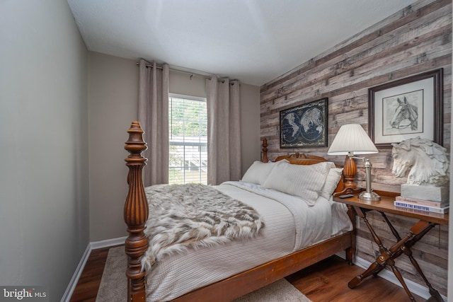 7781 Monaghan Rd, Glen Burnie, MD 21060 - bedroom with wooden walls, wood finished floors, and an accent wall
