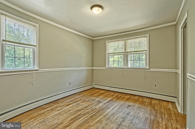 34 Barrett Ave, Hammonton, NJ 08037 - empty room featuring plenty of natural light, wood finished floors, crown molding, and a baseboard heating unit