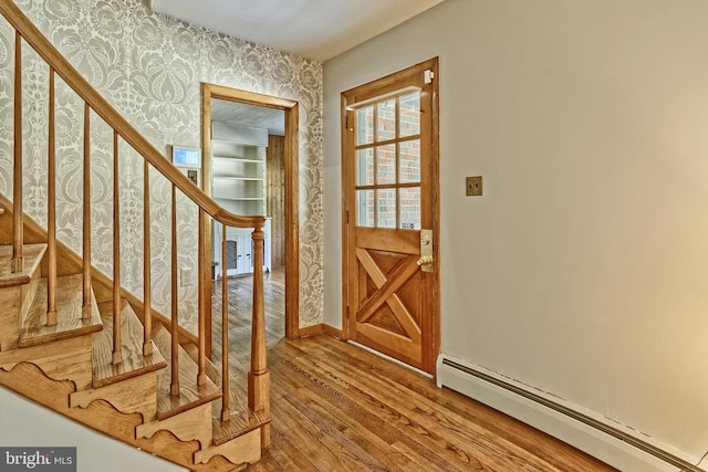 34 Barrett Ave, Hammonton, NJ 08037 - foyer entrance with baseboard heating, wallpapered walls, wood finished floors, and stairway