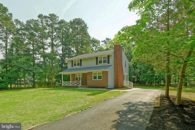 34 Barrett Ave, Hammonton, NJ 08037 - traditional home featuring covered porch, a chimney, brick siding, a front yard, and asphalt driveway