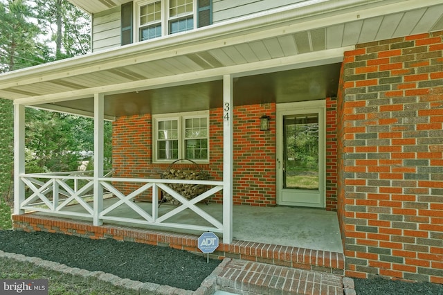 34 Barrett Ave, Hammonton, NJ 08037 - view of exterior entry featuring a porch and brick siding