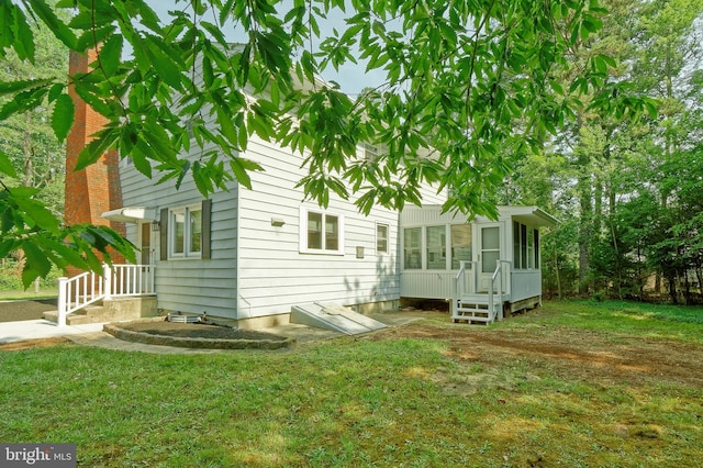 34 Barrett Ave, Hammonton, NJ 08037 - back of house with a sunroom and a lawn