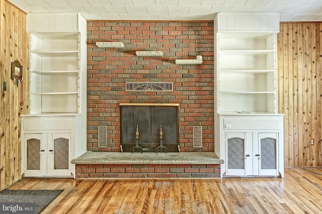 34 Barrett Ave, Hammonton, NJ 08037 - unfurnished living room with wood finished floors, wooden walls, a fireplace, and french doors