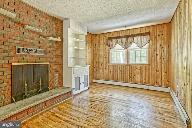 34 Barrett Ave, Hammonton, NJ 08037 - unfurnished living room with hardwood / wood-style flooring, a fireplace, a baseboard radiator, and wooden walls