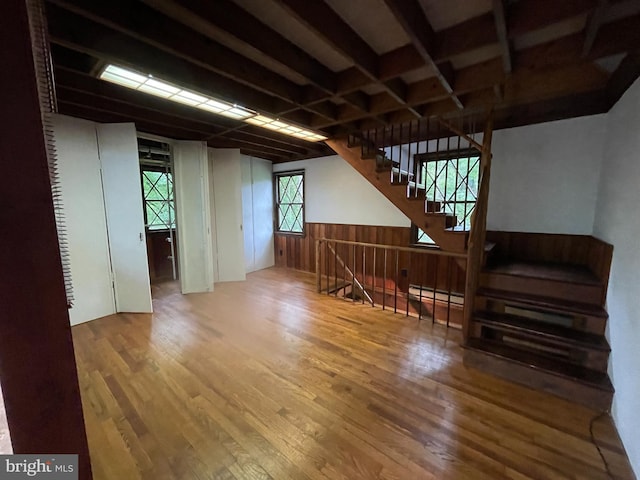 175 Howellsville Rd, Front Royal, VA 22630 - unfurnished living room featuring wood finished floors, a baseboard radiator, and stairs