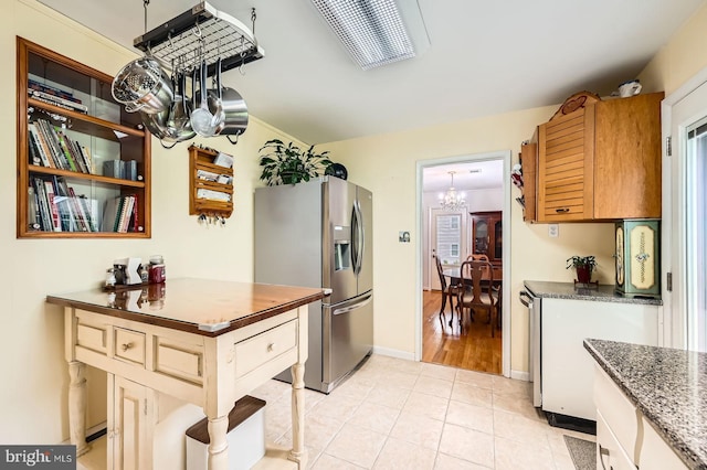 12105 Lanham Severn Rd, Bowie, MD 20720 - kitchen featuring stainless steel fridge with ice dispenser, a chandelier, light tile patterned floors, and dark stone counters