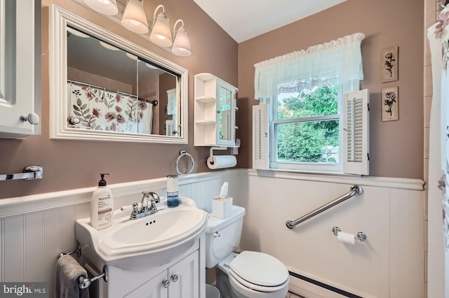 12105 Lanham Severn Rd, Bowie, MD 20720 - bathroom featuring wainscoting, vanity, a decorative wall, curtained shower, and a baseboard heating unit