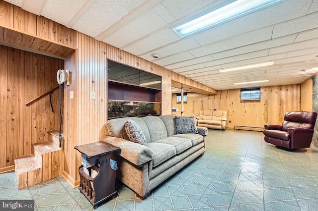 12105 Lanham Severn Rd, Bowie, MD 20720 - living room featuring wooden walls, tile patterned floors, baseboard heating, and stairway