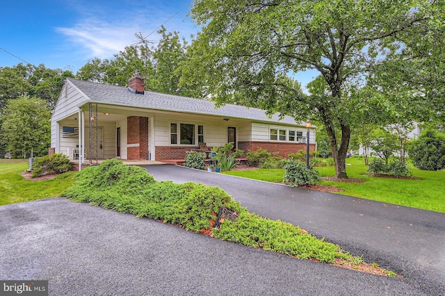 12105 Lanham Severn Rd, Bowie, MD 20720 - single story home featuring brick siding, driveway, a chimney, and a front yard