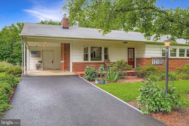 12105 Lanham Severn Rd, Bowie, MD 20720 - single story home featuring brick siding, a chimney, asphalt driveway, an attached carport, and a front yard