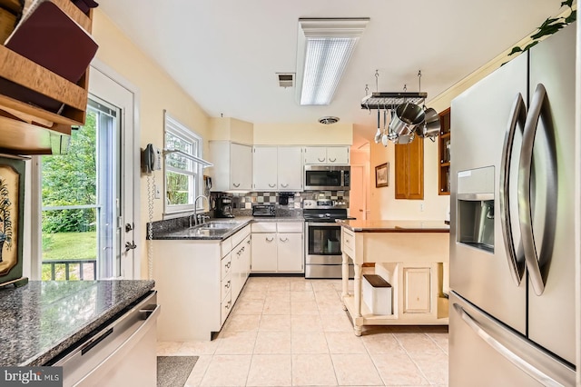 12105 Lanham Severn Rd, Bowie, MD 20720 - kitchen featuring stainless steel appliances, decorative backsplash, light tile patterned floors, white cabinets, and open shelves