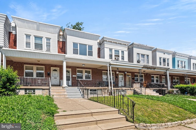 5242 Sylvester St, Philadelphia, PA 19124 - view of property with a porch, brick siding, and a front yard
