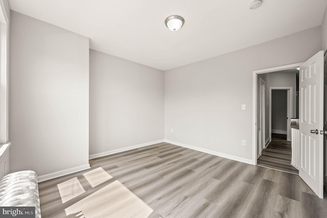 5242 Sylvester St, Philadelphia, PA 19124 - spare room with wood finished floors and a smoke detector