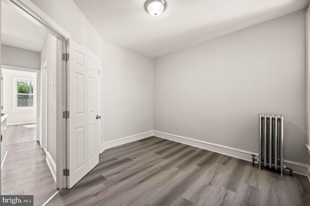 5242 Sylvester St, Philadelphia, PA 19124 - unfurnished room featuring radiator heating unit and wood finished floors