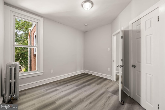 5242 Sylvester St, Philadelphia, PA 19124 - empty room featuring radiator and wood finished floors