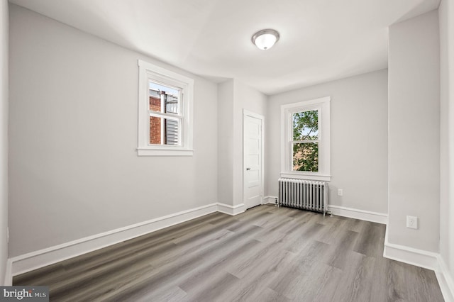 5242 Sylvester St, Philadelphia, PA 19124 - spare room featuring radiator heating unit and wood finished floors