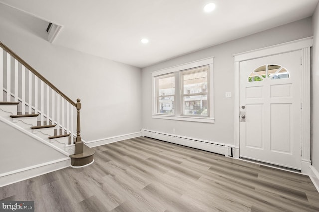 5242 Sylvester St, Philadelphia, PA 19124 - entrance foyer featuring a baseboard heating unit, wood finished floors, plenty of natural light, recessed lighting, and stairs