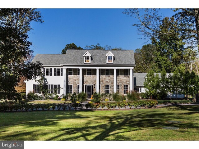 2103 Street Rd, New Hope, PA 18938 - greek revival house featuring a front yard and stone siding