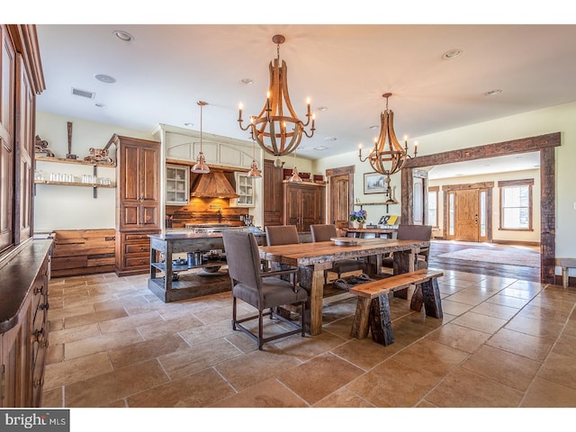 2103 Street Rd, New Hope, PA 18938 - dining area featuring a chandelier, stone tile floors, and recessed lighting