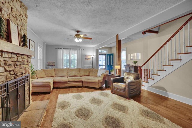 120 Hook St, Birdsboro, PA 19508 - living area featuring wood finished floors, a textured ceiling, ceiling fan, and stairs
