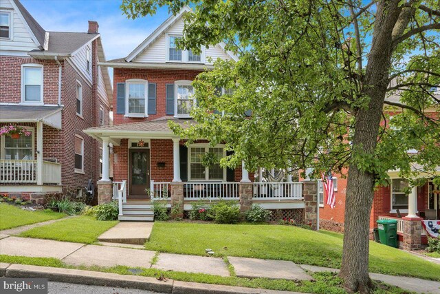 120 Hook St, Birdsboro, PA 19508 - view of front of house with covered porch, a front yard, and brick siding