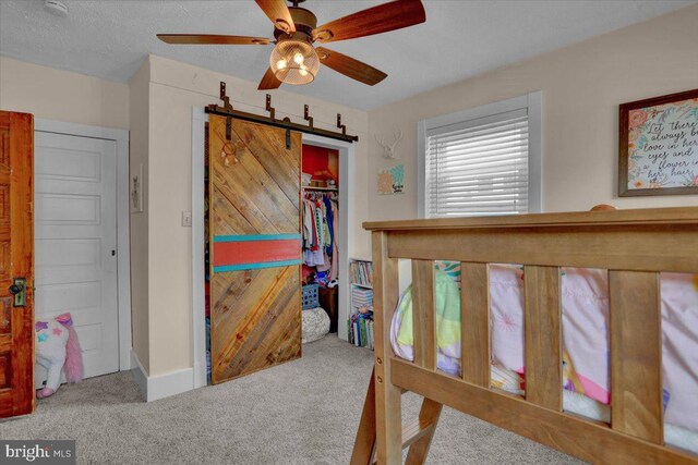 120 Hook St, Birdsboro, PA 19508 - bedroom with carpet floors, a barn door, a closet, and a ceiling fan