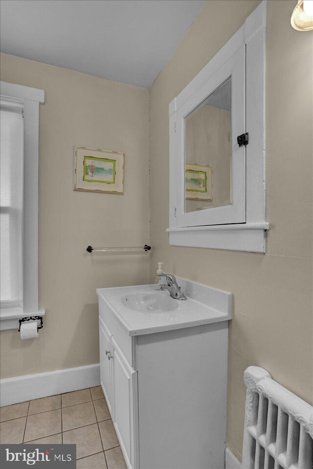 120 Hook St, Birdsboro, PA 19508 - bathroom with radiator, vanity, and tile patterned flooring