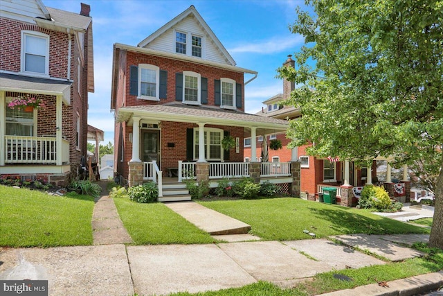 120 Hook St, Birdsboro, PA 19508 - view of front of home with covered porch, brick siding, and a front lawn