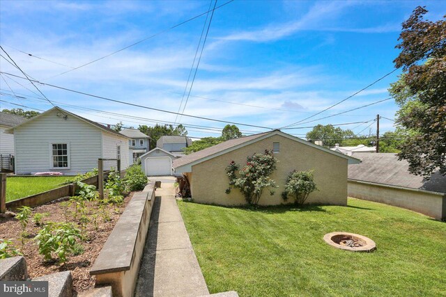 120 Hook St, Birdsboro, PA 19508 - view of yard with a fire pit, a garage, driveway, and an outdoor structure