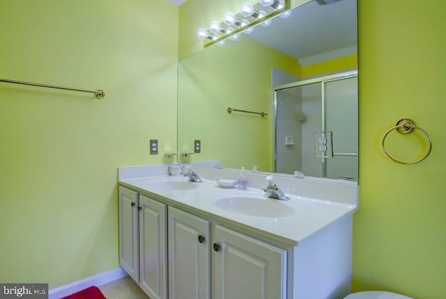 6180 Marsh Island Dr, Chincoteague Island, VA 23336 - bathroom featuring double vanity and a shower with door