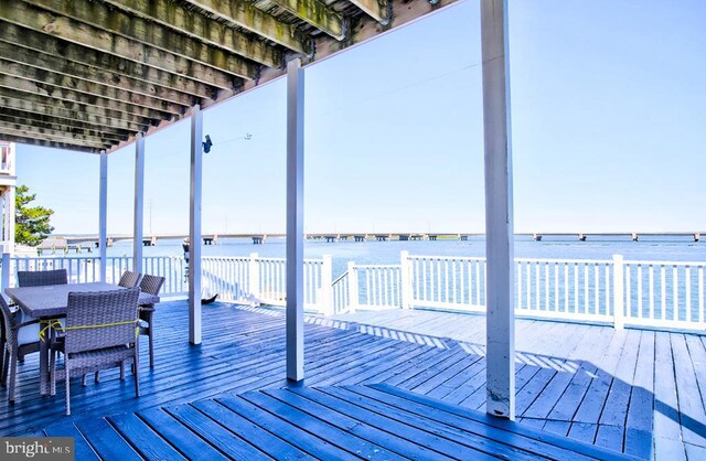 6180 Marsh Island Dr, Chincoteague Island, VA 23336 - dock area featuring outdoor dining area and a deck with water view